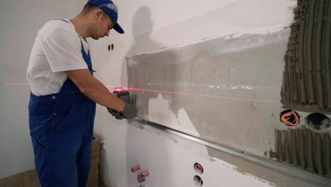 installing ceramic wall tiles - measuring and cutting the pieces. construction, renovation, repair apartment. cuts tile. tile cutting