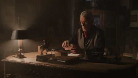 older passionate man evaluates an old porcelain box