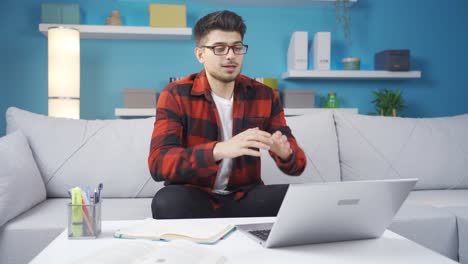 Young-man-working-from-home-talking-facetime-at-business-meeting.