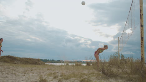 match on competition by beach volleyball women teams are competing playing on sandy court passing ball and attack