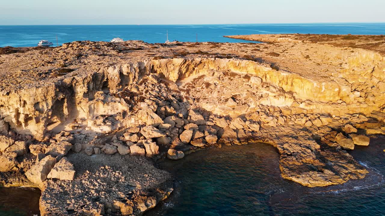 Aerial - rocky coastal limestone cliff near Mediterranean sea, Cyprus