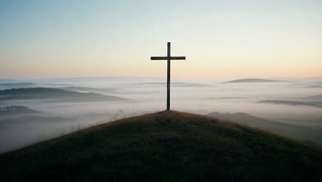 cross on a hilltop at sunrise/sunset