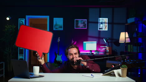 playful influencer hiding under desk, pointing to empty copy space sign