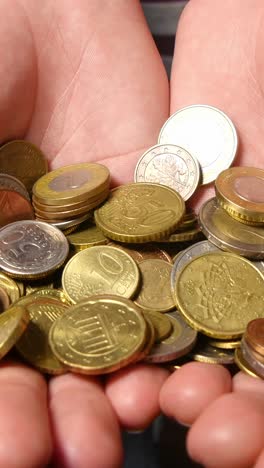 hand holding euro coins money