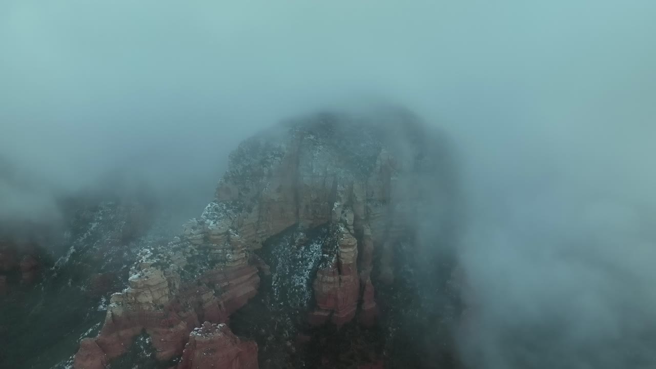 Snow Over Sandstone Sedimentary Rock Mountains Of Sedona During Foggy Morning In Arizona, USA