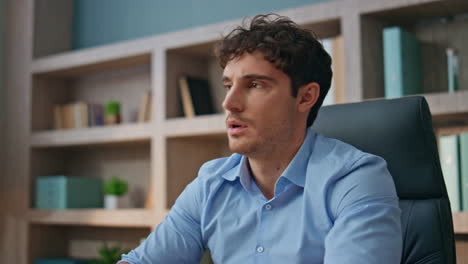 exhausted businessman finishing work rubbing eyes. closeup man closing laptop