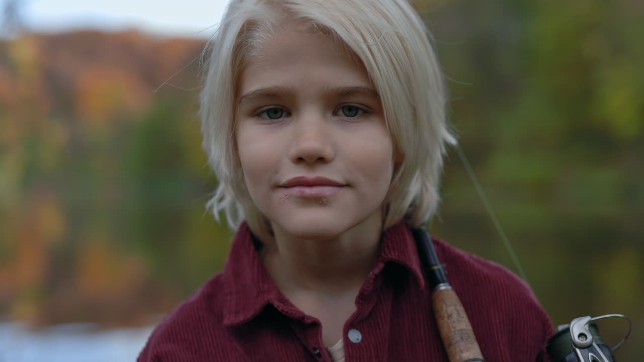 Young Boy Holding a Fishing Rod