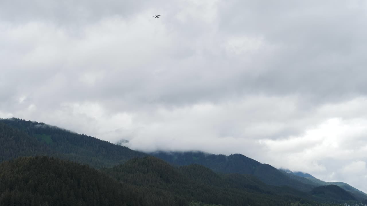 Waterplane flying over Juneau, Alaska, in a rainy day.
