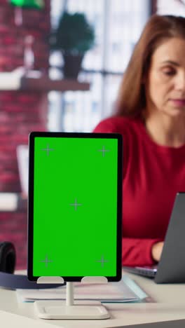 vertical video person uses laptop for creative projects next to isolated copy space