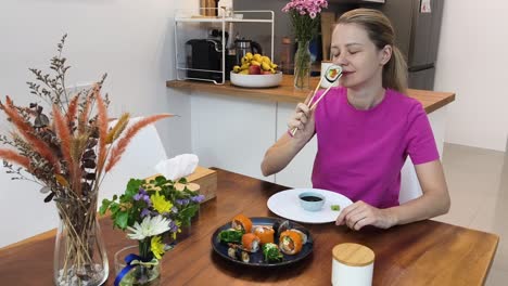 woman eating sushi at home