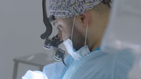 surgeon performing surgery with magnification tools