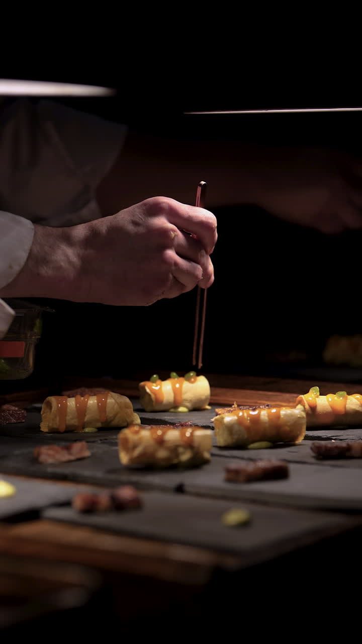 Close-up of a chef precisely decorating gourmet bites, showcasing the art of plating in a professional kitchen