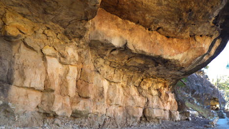 sandstone walls of cliff dwellings at walnut canyon by trail path