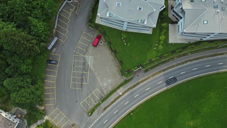 cinematic overhead view of the car driving on empty road in swiss village road, sorenberg, switzerland