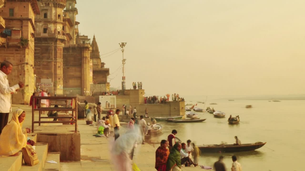 Time lapse Indian pilgrims rowing boat in sunrise. Ganges river at Varanasi India.