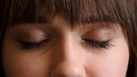 closeup of a woman with blue eyes on dark studio