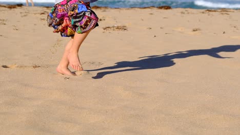 little girl enjoying running along the beach