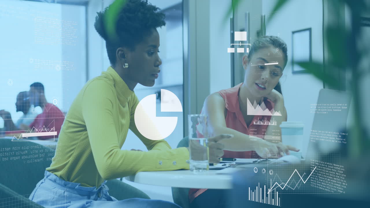 Animation of statistical data processing against two diverse women discussing over laptop at office