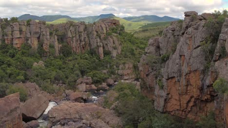 drone aerial reveal shot near blyde river canyon at the amber 'treur' falls in mpamalunga, south africa