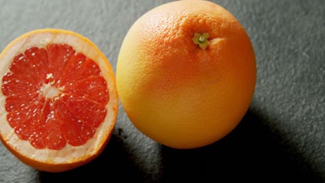 grapefruit with half grapefruit on grey background 4k 4k