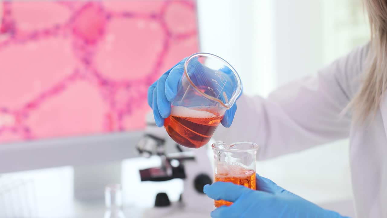 Scientist pouring liquid in laboratory