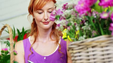 female florist writing on clipboard