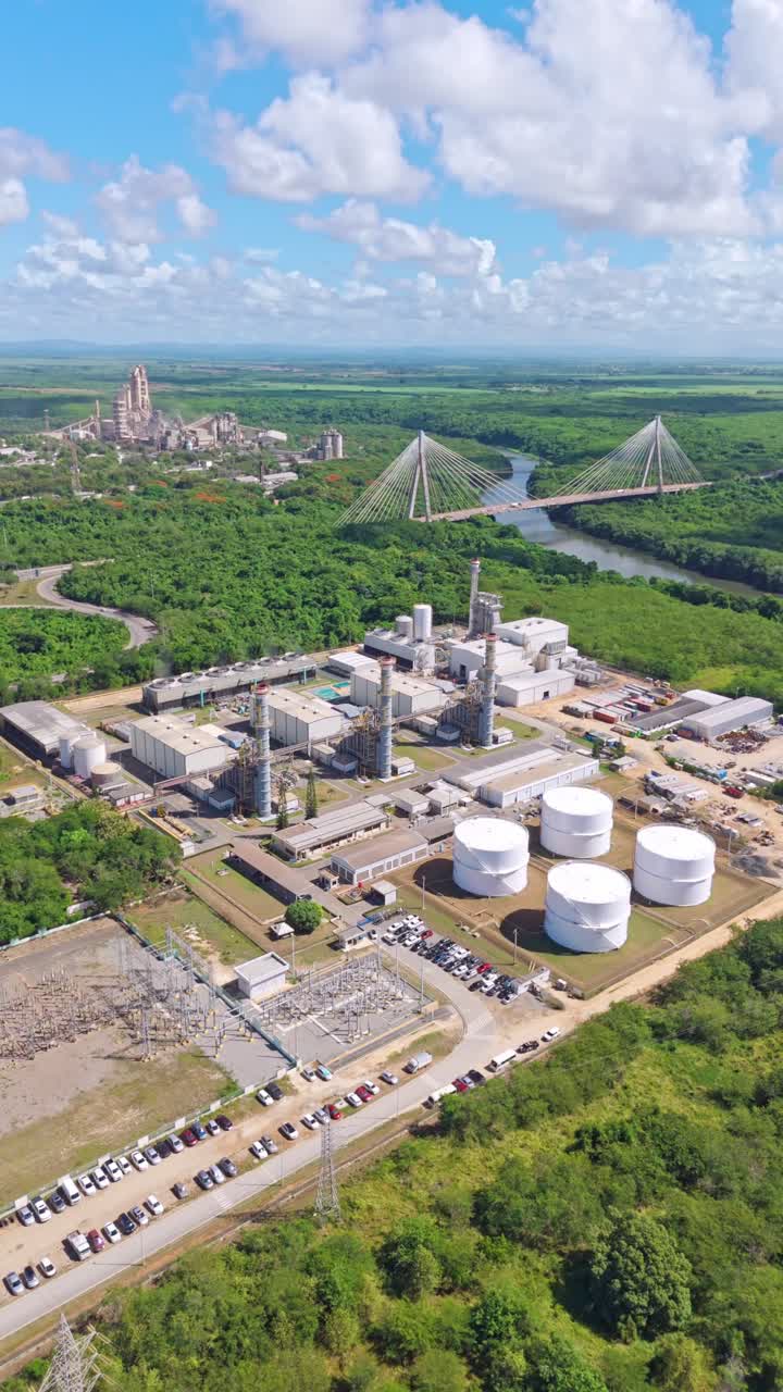 Pan view of the Energa 4 power generation facility, fuel storage tanks, substation, and smokestacks in San Pedro de Macoris, Dominican Republic