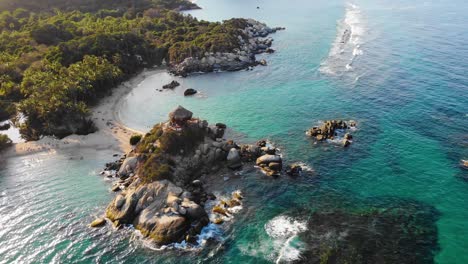 Aerial-view-overlooking-the-rocky-coast-and-beaches-of-San-Juan-in-Tayrona,-Colombia---dolly,-drone-shot