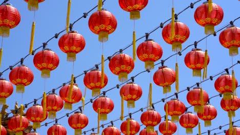 beautiful red lanterns sway in the breeze against the light blue sky