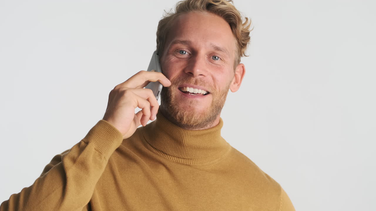 Happy guy having a conversation on phone