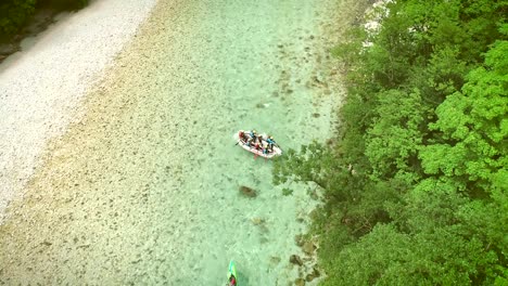 aerial view rafters doing rafting in turquoise water going down at soca river.