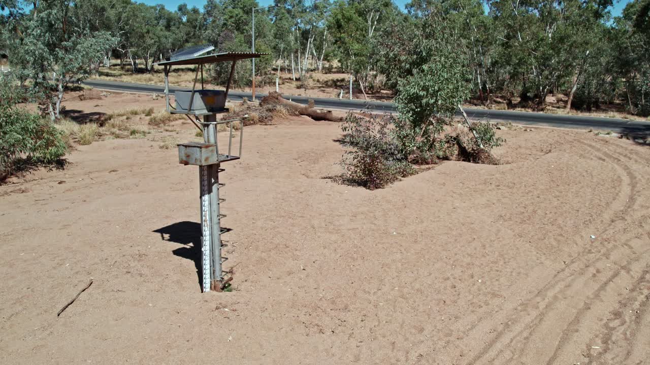 Rising and panning down drone footage of the stream gauge on the Todd River at Heavitree Gap (station G0060126), Alice Springs, Mparntwe. Northern Territory, Australia. August 2022.