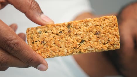 person holding a granola bar