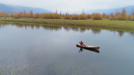 man rowing a boat on a lake 4k