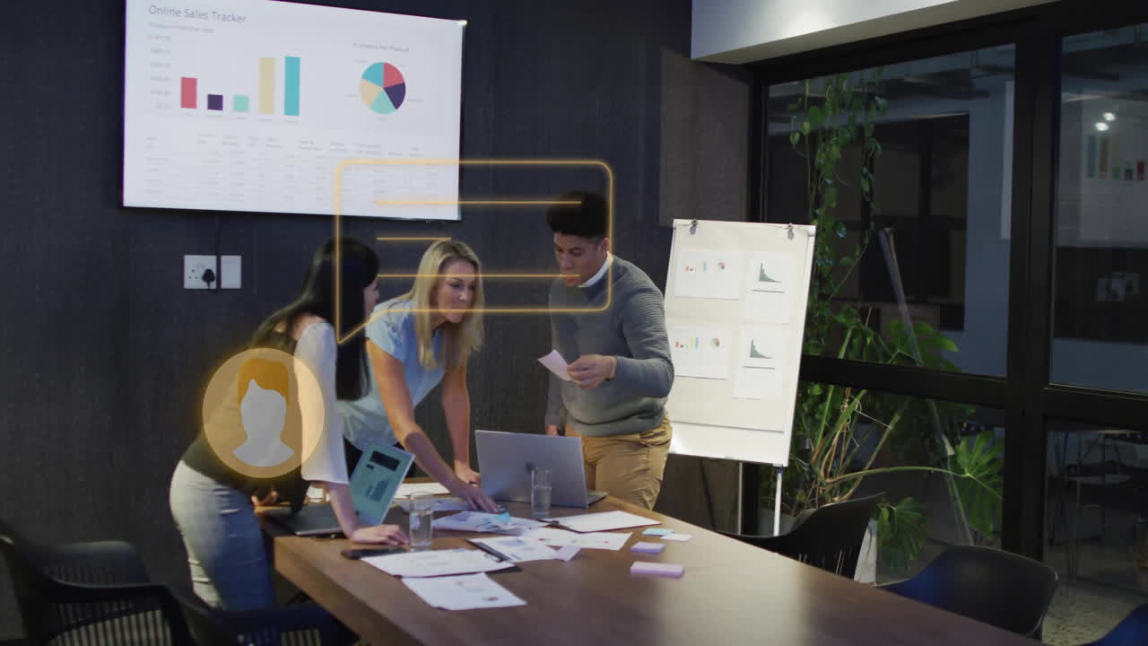 Collaborating over sales charts, business team analyzing data in modern office