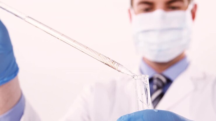 Lab technician checking sample in tube