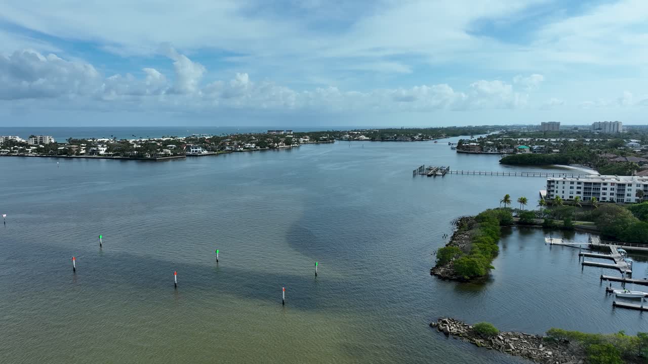 Drone flying southeast over the Intracoastal Waterway from Intracoastal Park in Boynton Beach Florida showing the Atlantic Ocean in the distance