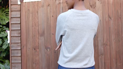 Midsection-rear-view-of-african-american-woman-wearing-grey-sweatshirt,-slow-motion,-copy-space