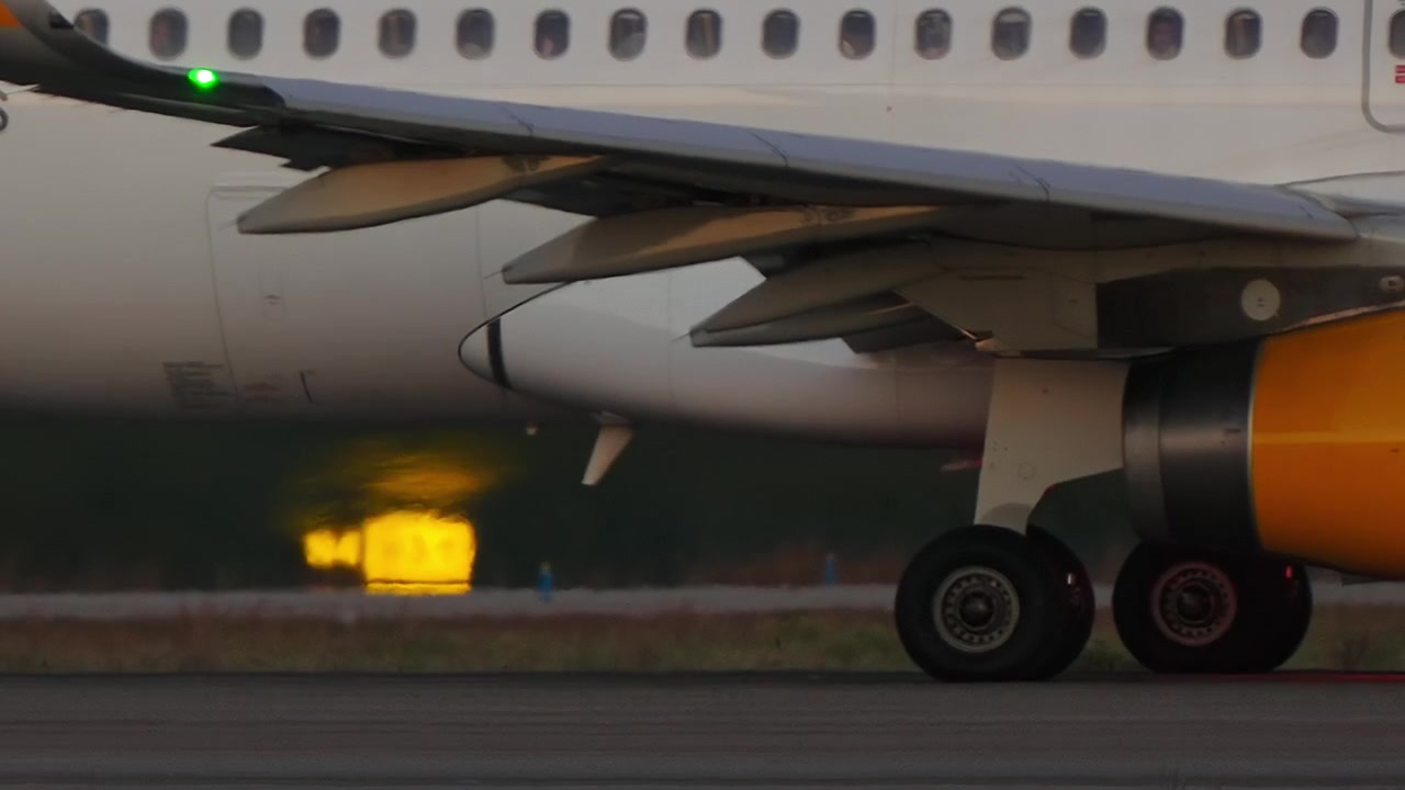 Airplane on Runway at Sunset Close Up