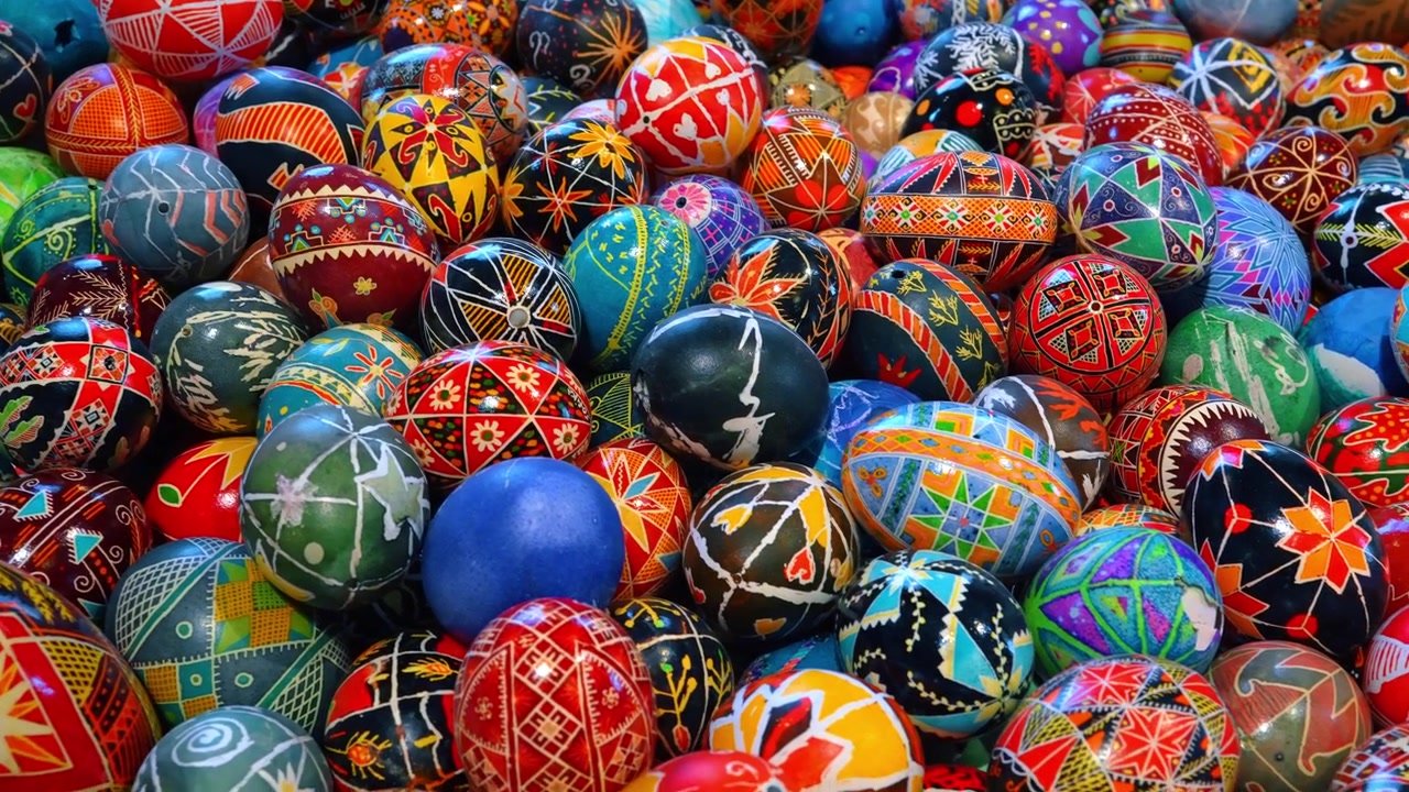 Detailed view of colorful hand painted Ukrainian Pysanky eggs. Close-up top view of numerous colorful Pysanky eggs featuring traditional geometric and floral designs in New York.