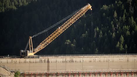 Crane-and-workers-busy-at-work-on-a-large-construction-in-countryside