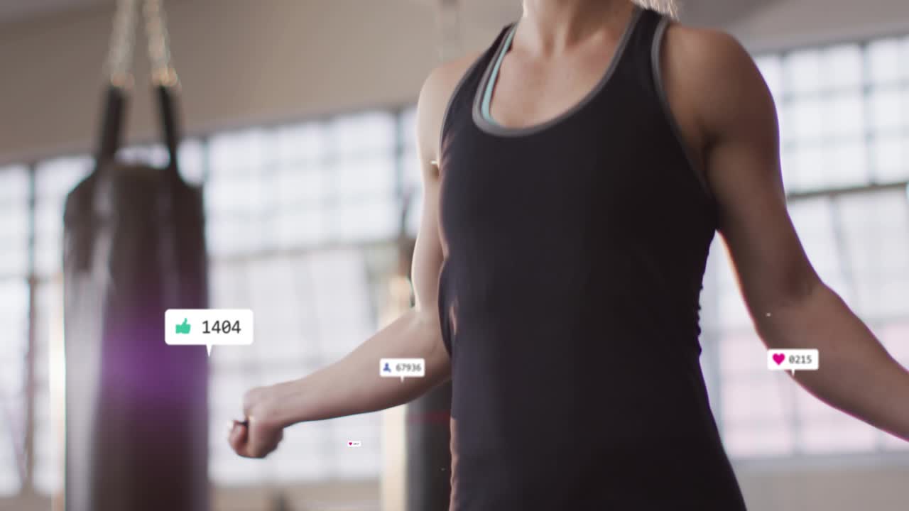 Woman skipping rope in gym, jump causing animated hearts and followers circling body seeking likes