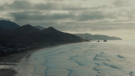 4k aerial beach on west coast of oregon with mountains in background drone truck right