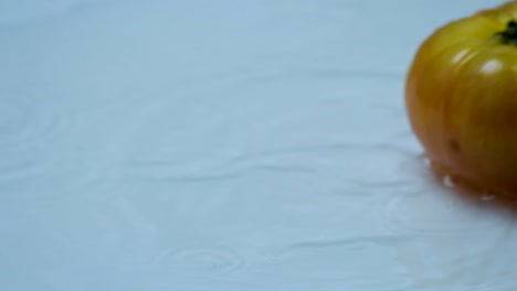 Super-Slow-Motion:-Tomato-Cascading-onto-Water-Drenched-Table