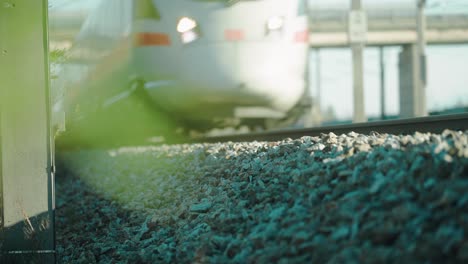 a high-speed train running at full speed passing by filmed very close to the train tracks with a tele lens