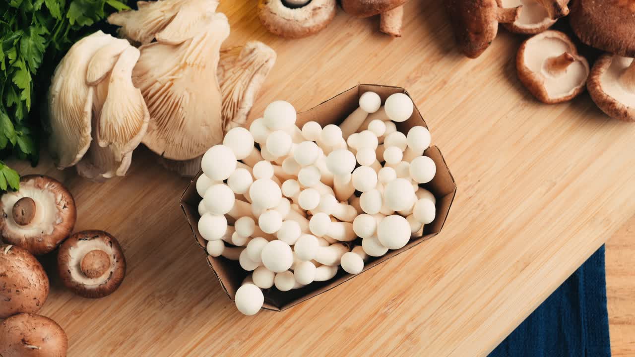 Variety of Fresh Mushrooms on a Wooden Cutting Board