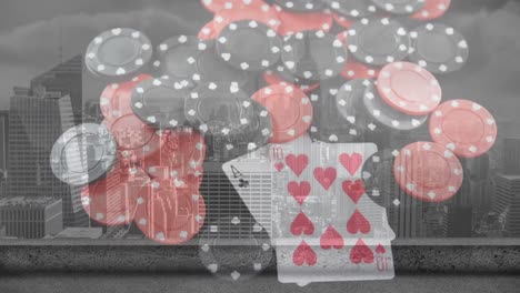 Animation-of-playing-cards-and-chips-on-board-over-cityscape