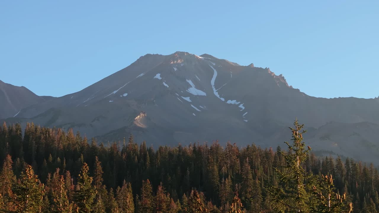 Scenic view of Mt. Shasta, serene mountain sunrise over forest