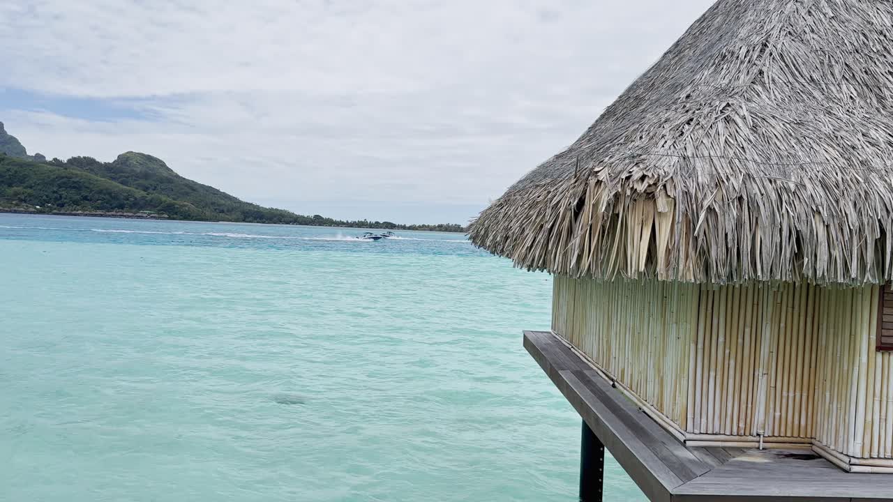 Summer Bora Bora Vacation Resort in French Polynesia with turquoise and aquamarine shallow lagoon clear water