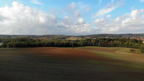 aerial shot of meadow and lake in kolbudy, pomeranian district in poland